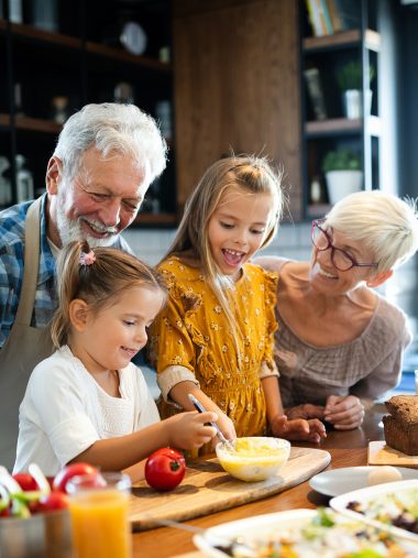 Großeltern kochen mit ihren Enkelinnen