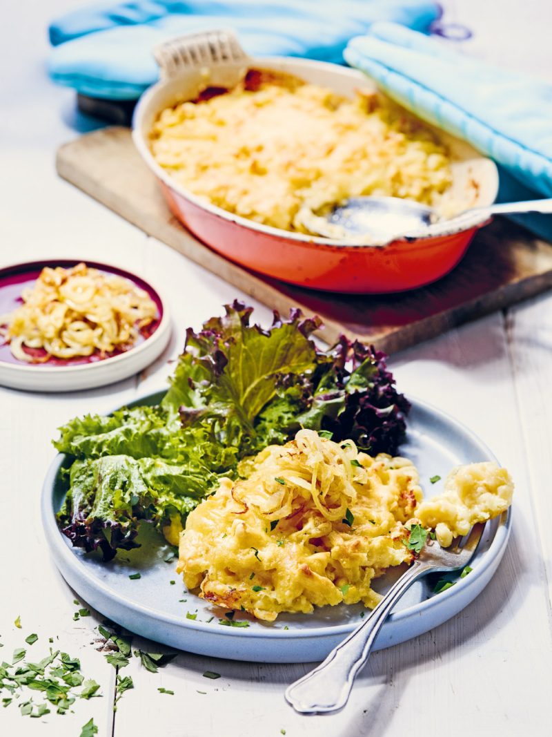 Fränkische Käsespätzle mit Salat auf einem weißen Teller