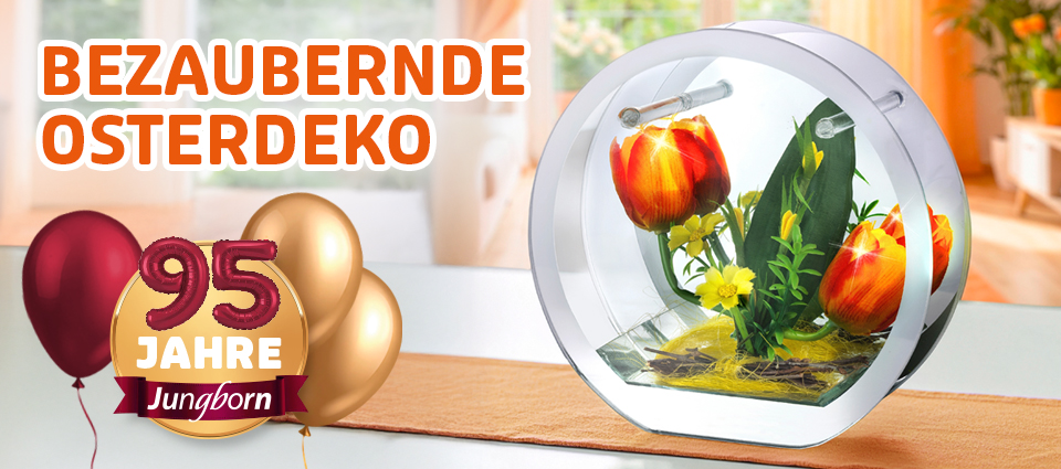 Osterdeko mit Tulpen im Glasgefäß auf Tisch