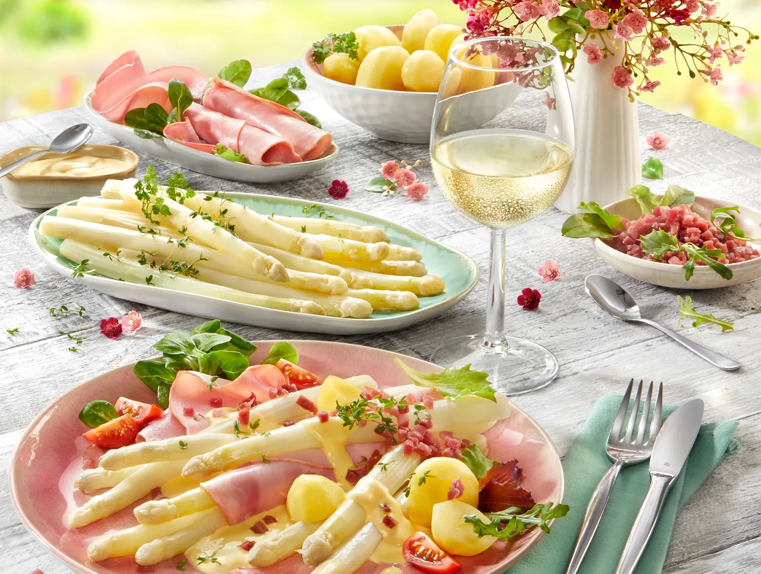 Frischer Spargel mit Schinken, Kartoffeln und Weißwein auf Frühlingsgedeck