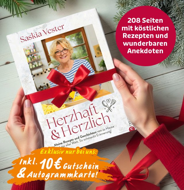 Kochbuch „Herzhaft & Herzlich“ von Saskia Vester mit roter Schleife als Geschenk