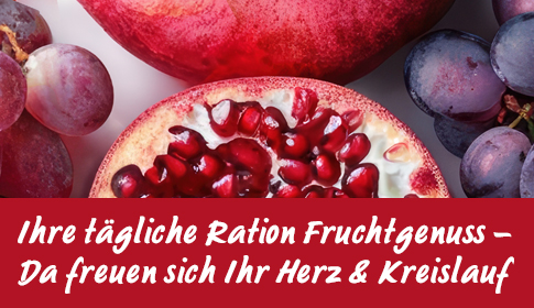 Fruchtgenuss für Herz & Kreislauf – Natürlich gesund! Aufgeschnittener Granatapfel und rote Trauben in Nahaufnahme.